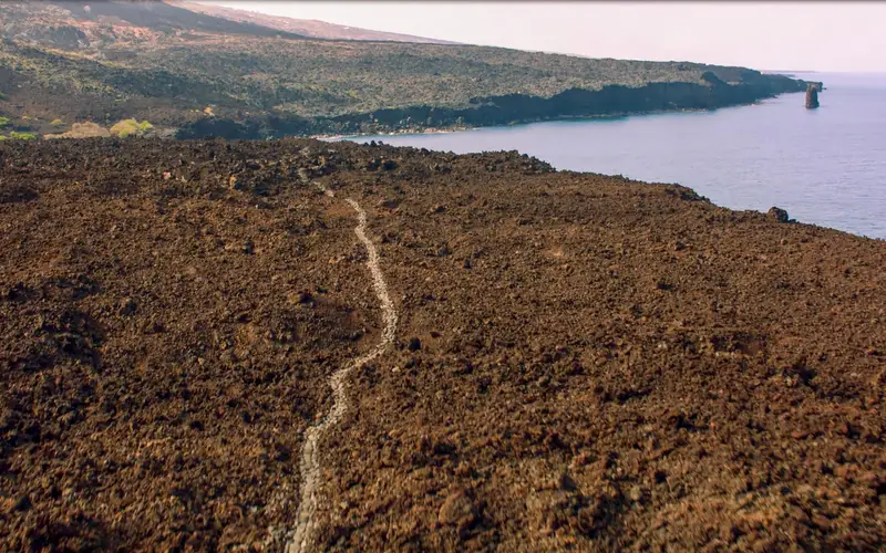 Aerial photograph of trail through lava along the Hawaiian Coast