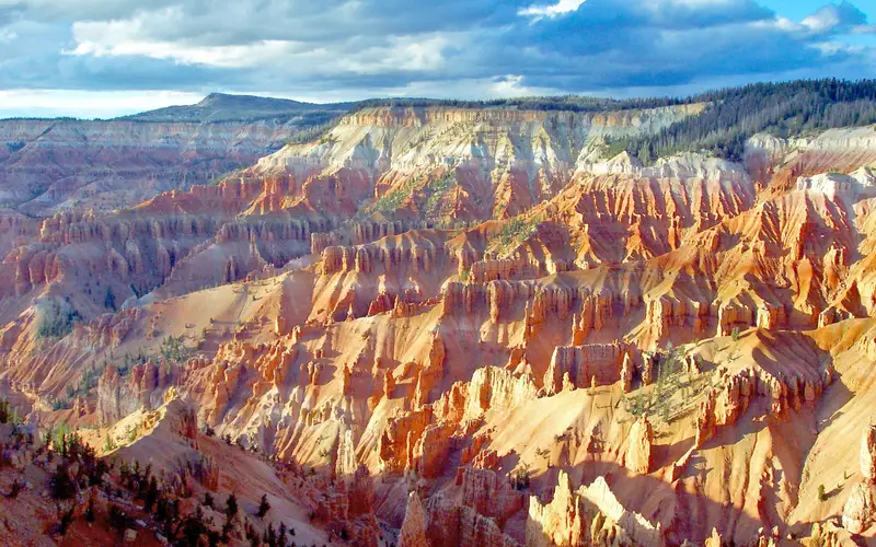 The ground falls away from the viewer creating brilliant rock formations of pink, red, and orange.