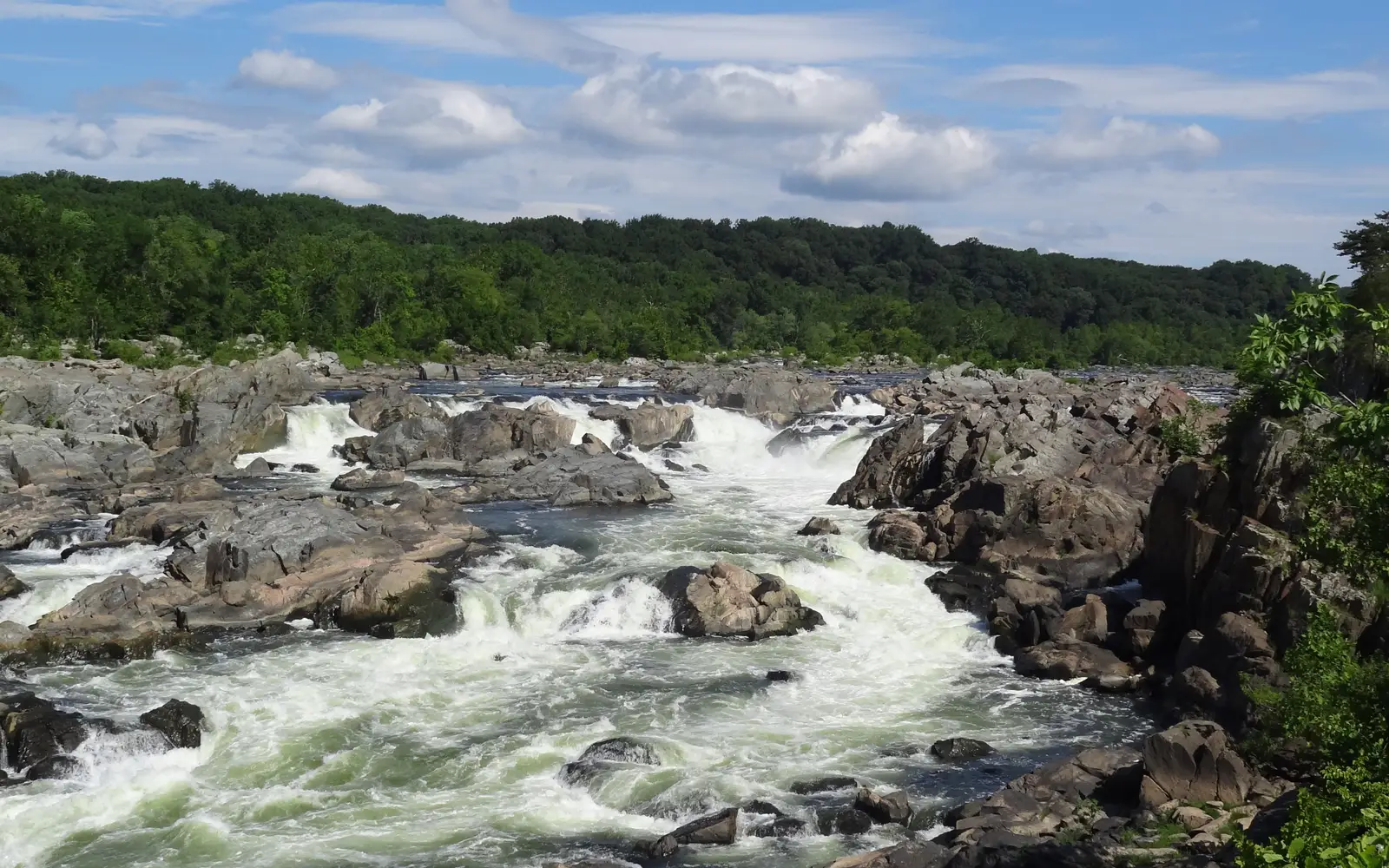 The rushing river cascades over the rocks of the Potomac