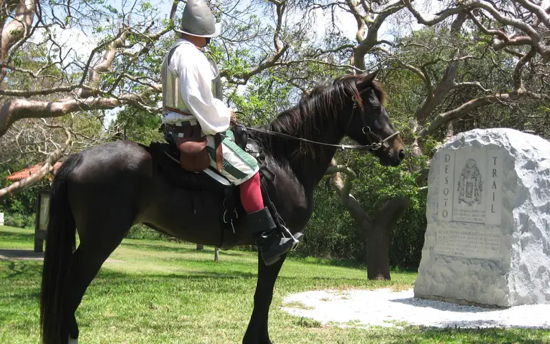 Reenactor Bill Boston on his horse Dixie in front of the De Soto Monument.