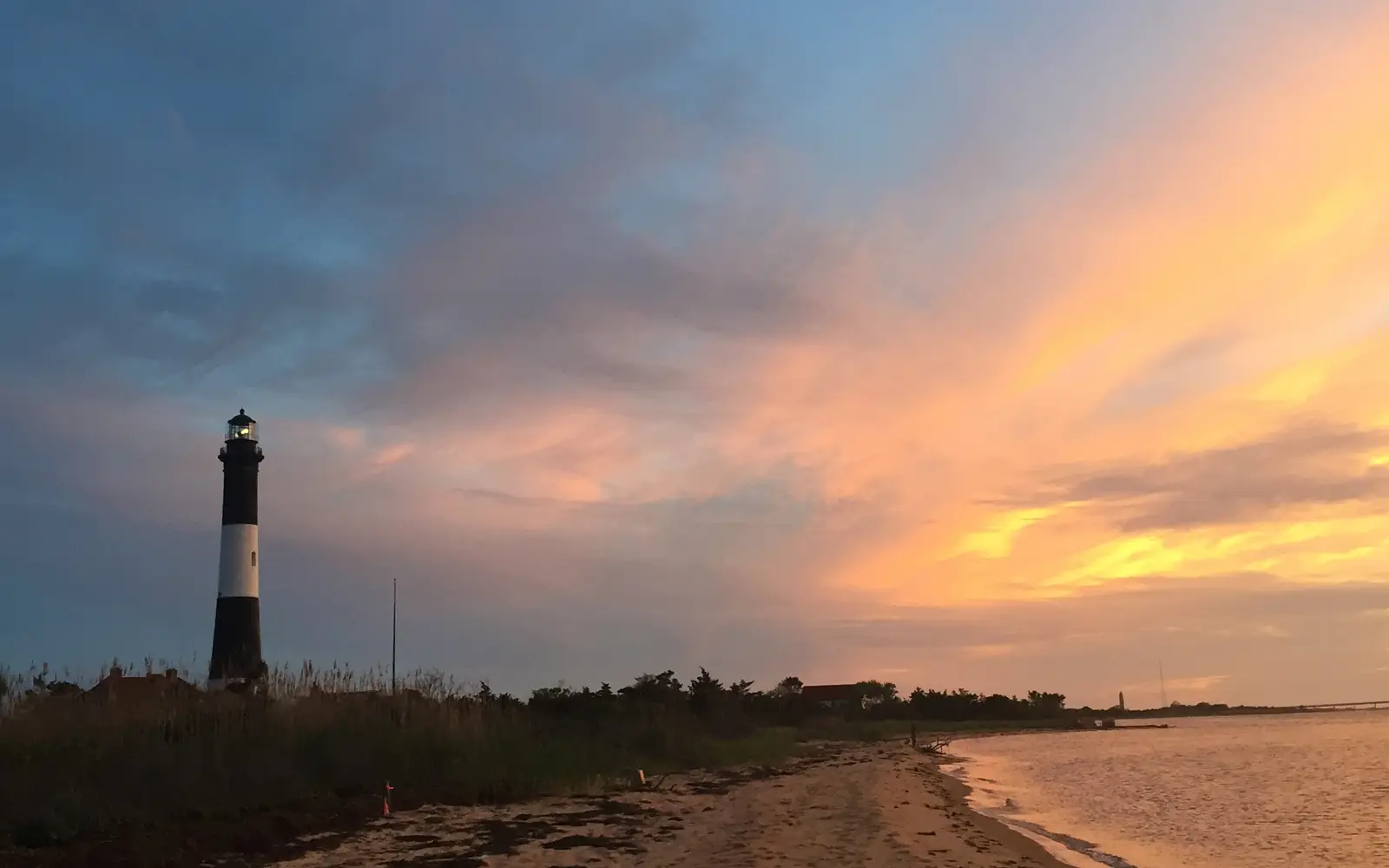 The Fire Island Lighthouse against a vibrant sunset.