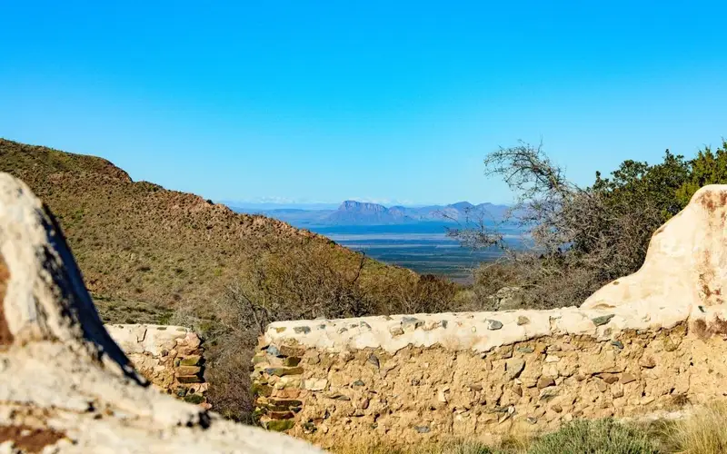 Ruins of the fort with mountains and valley in the background.