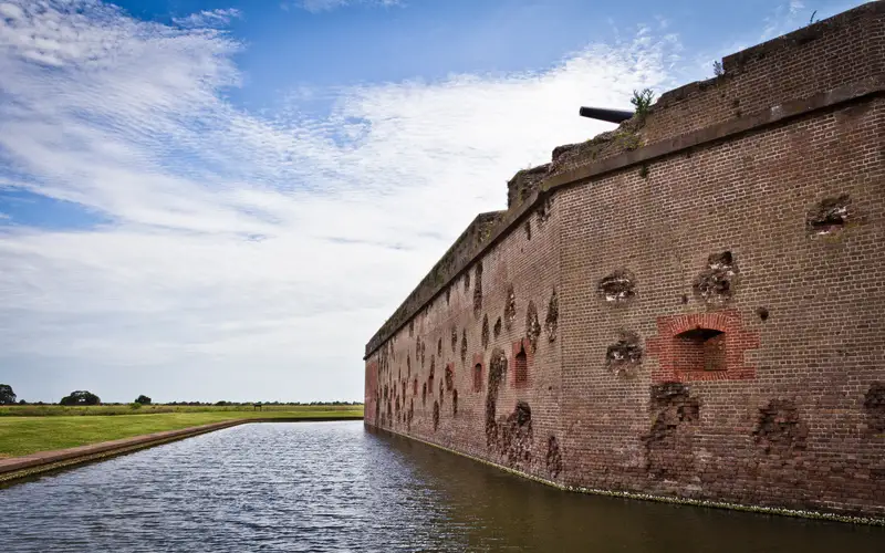 The red masonry walls of Fort Pulaski still show battle damage over 150 years later.