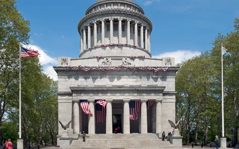 Mausoleum and flags in sunny weather