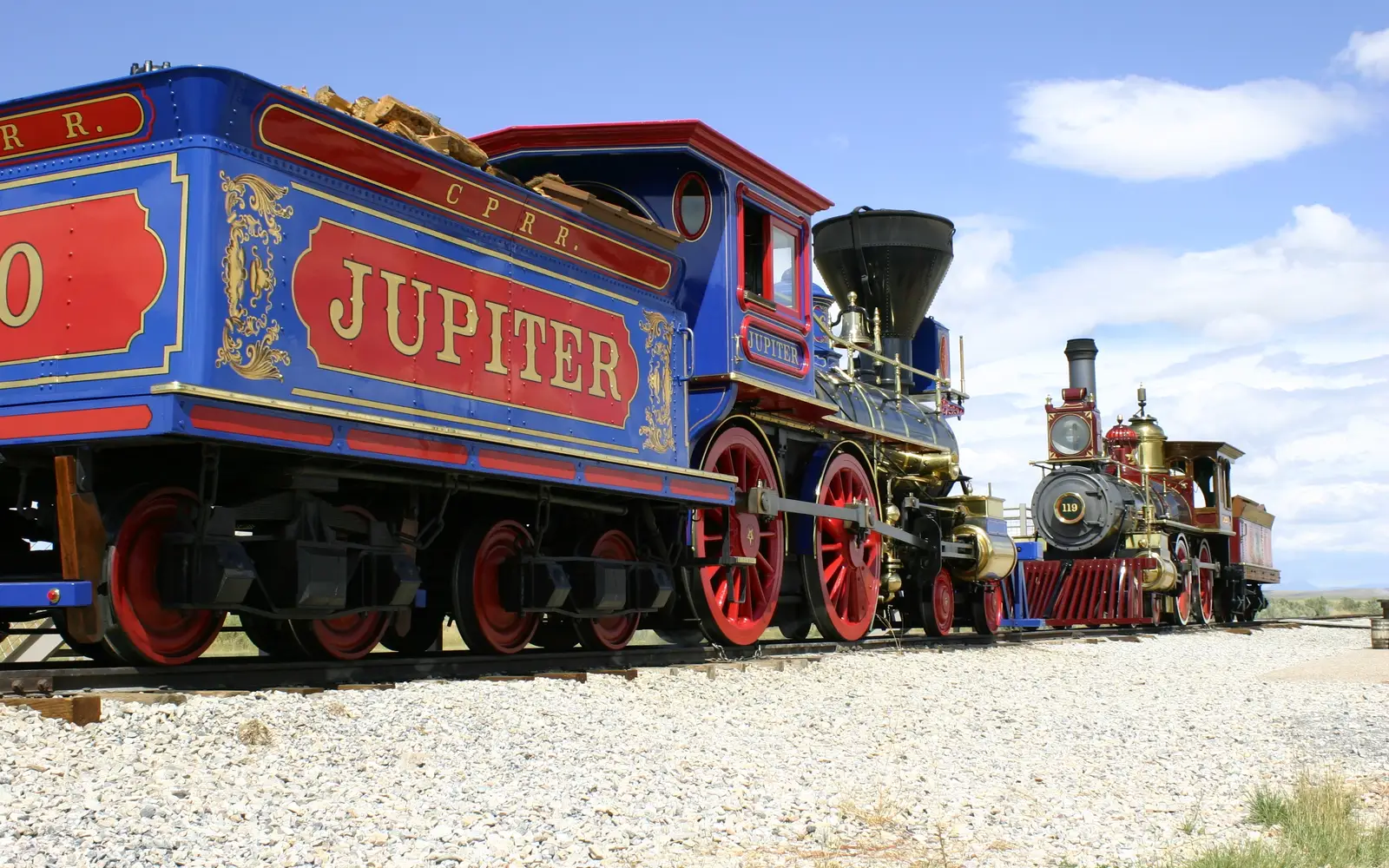 Two replica victorian age steam locomotives face each other on the original railroad grade