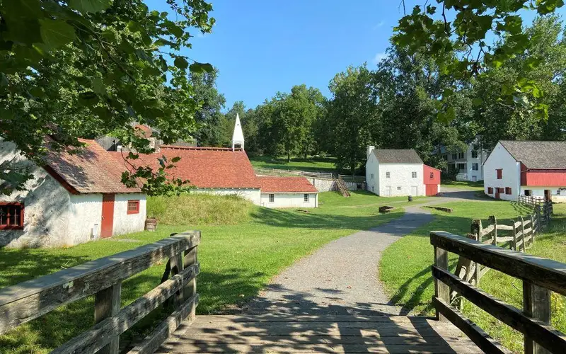 buildings varying in size on either side of a gravel path.