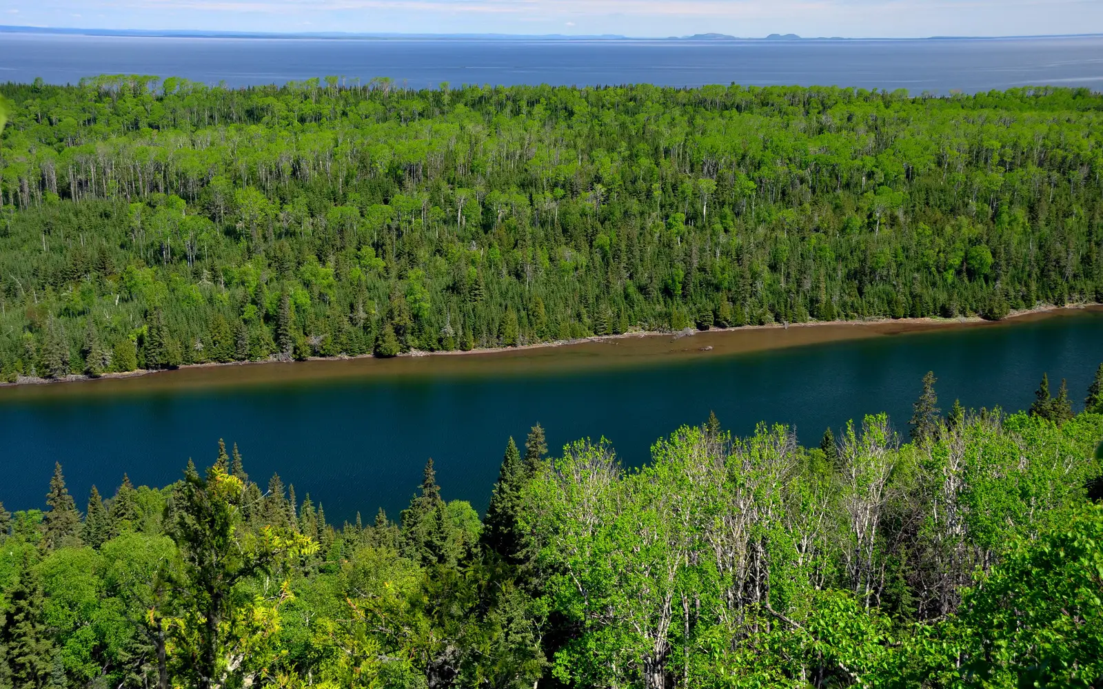 View from above the trees looking down at Duncan Bay Narrows, trees, Lake Superior, and Canada.