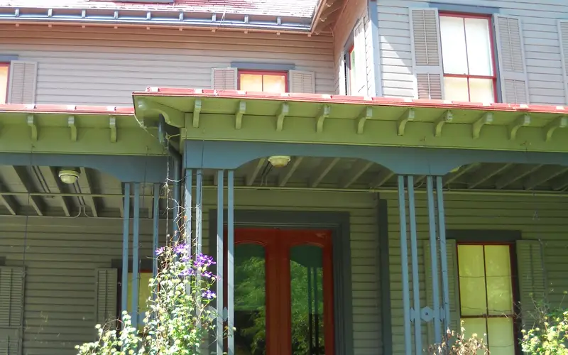 Front porch of Garfield home showing red front door