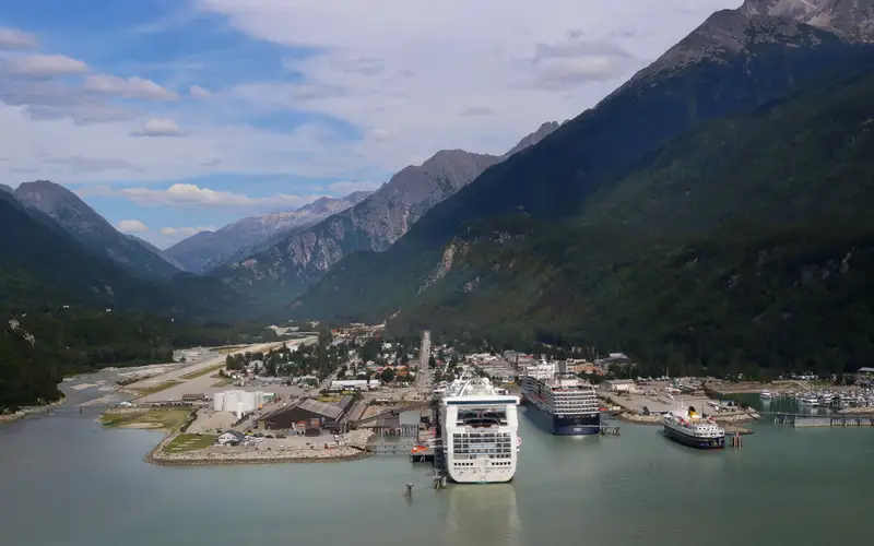 Aerial view of town in a valley with cruise ships in port