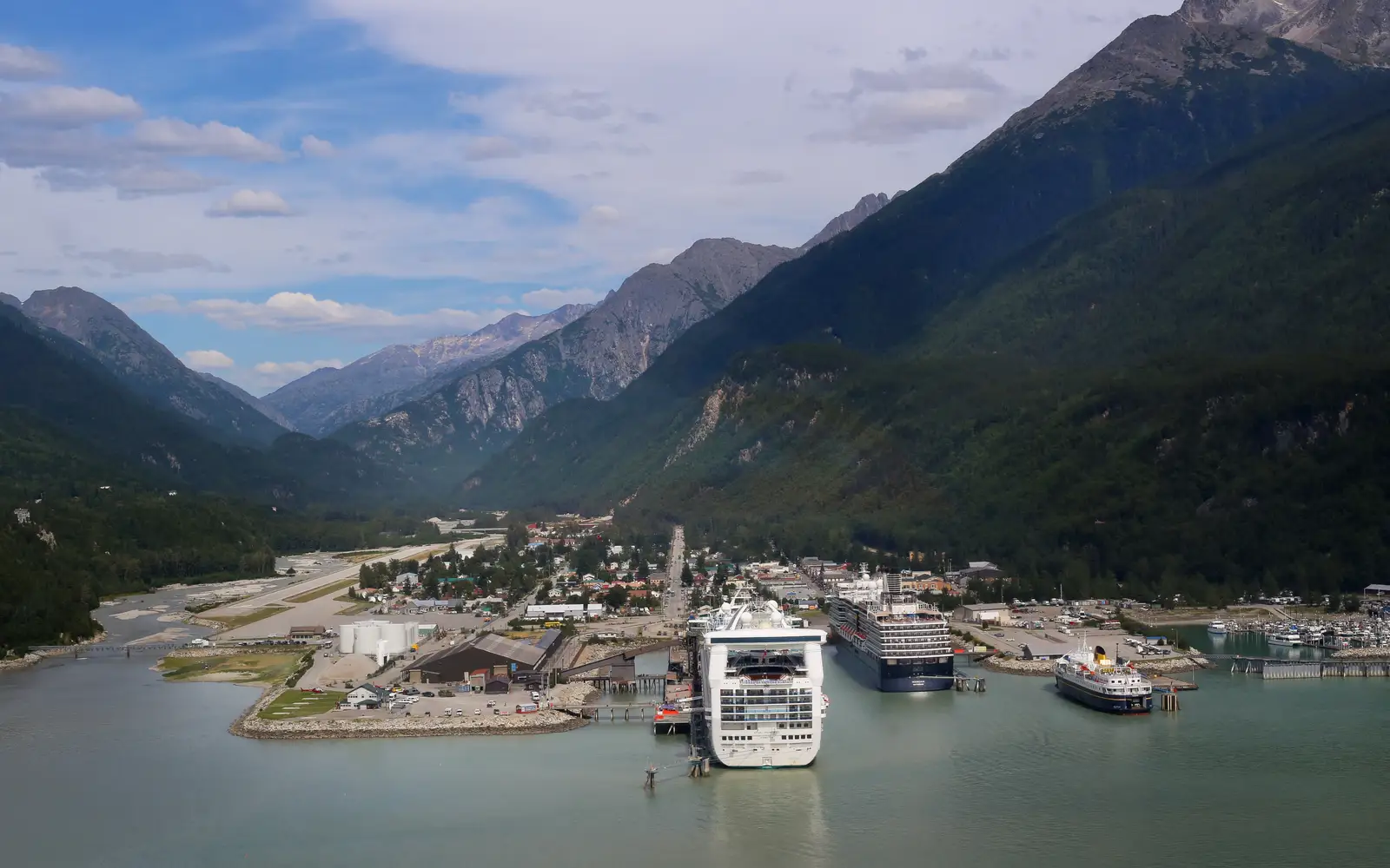 Aerial view of town in a valley with cruise ships in port
