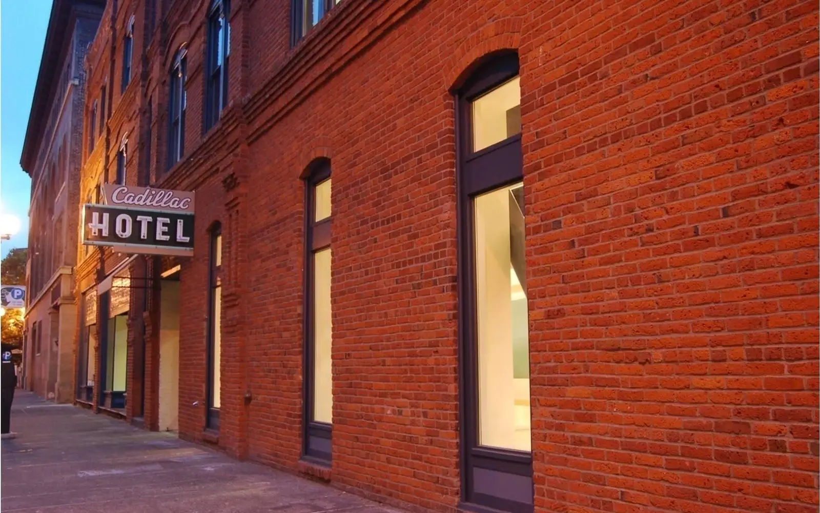 Large brick wall with glass windows.