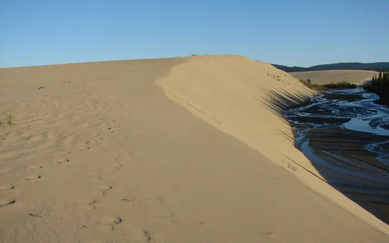 sun setting on sand dunes