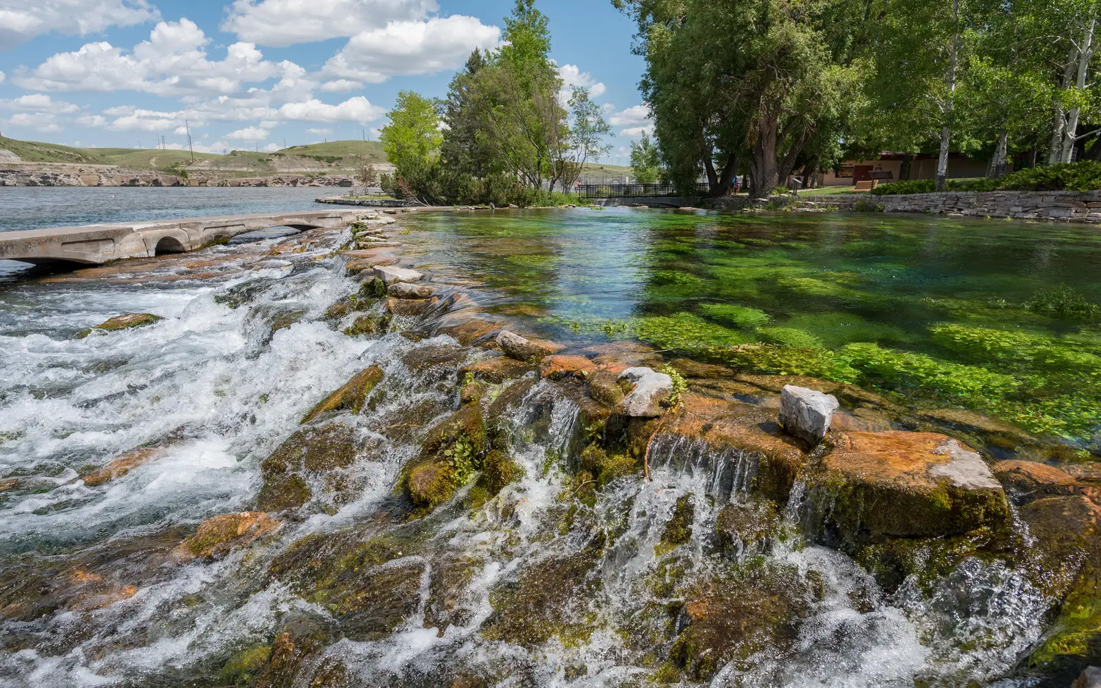 Small waterfall with brown rocks and green moss