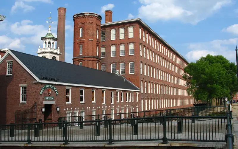 5 story brick factories with a clocktower surrounding a central courtyard