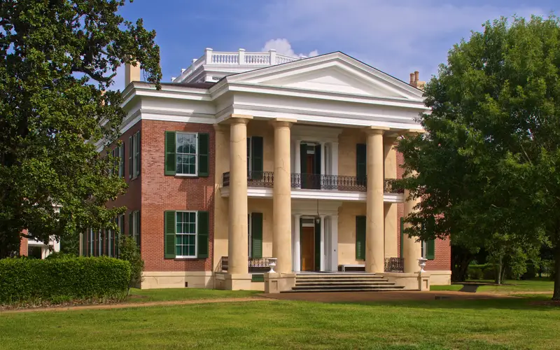 Two story brick mansion with columns