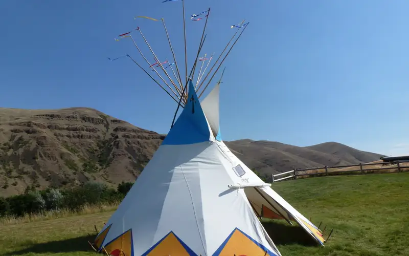Colorful painted tipi on green lawn