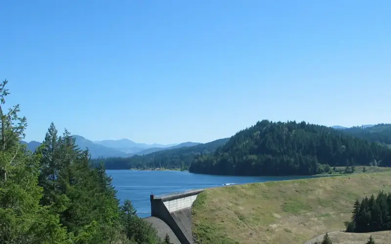 Earth Dam, Concrete Spillway, with lake and trees in the background