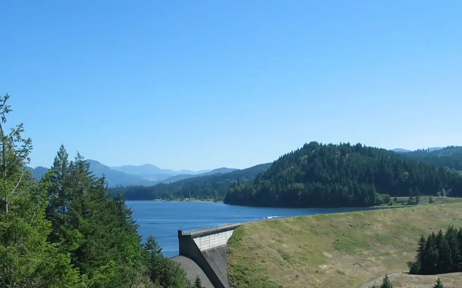 Earth Dam, Concrete Spillway, with lake and trees in the background