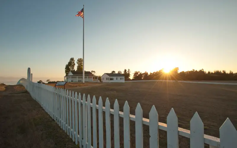 a sun setting behind historic parade grounds
