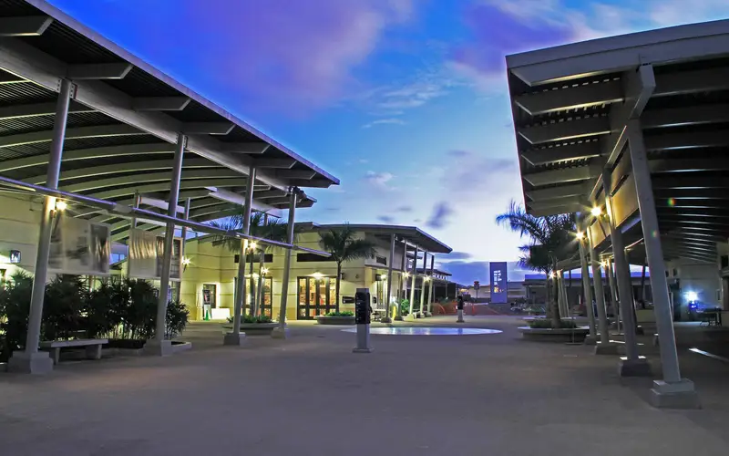 An evening photo of the Pearl Harbor Visitor Center Complex looking towards the museums.