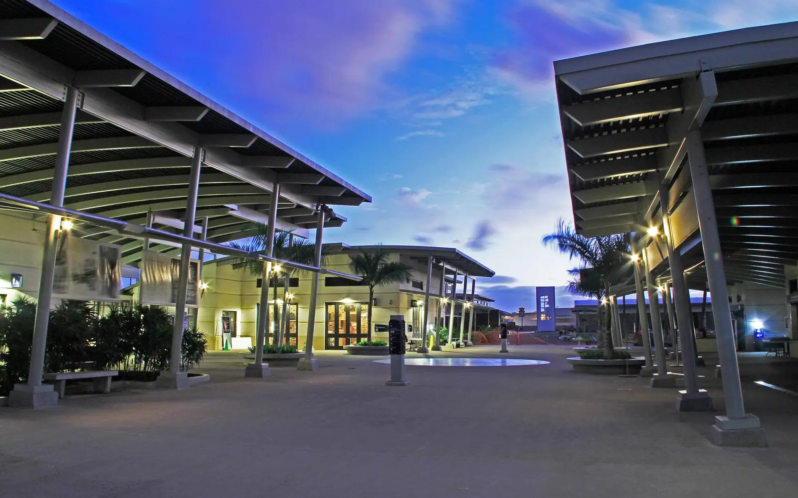 An evening photo of the Pearl Harbor Visitor Center Complex looking towards the museums.